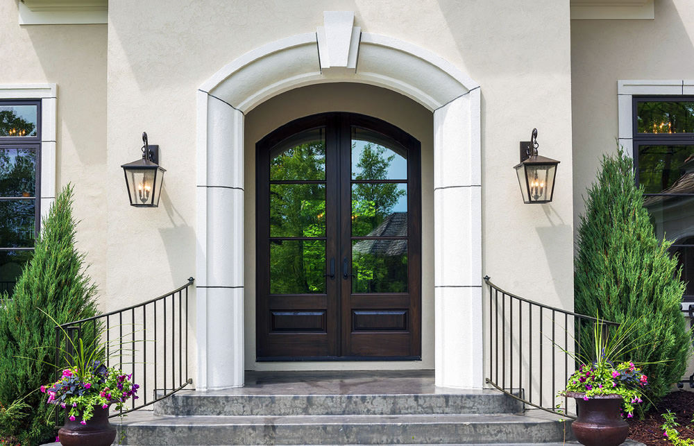 Contrasts of white stucco and rich chestnut browns in the wood create a memorable welcoming to this family's home.